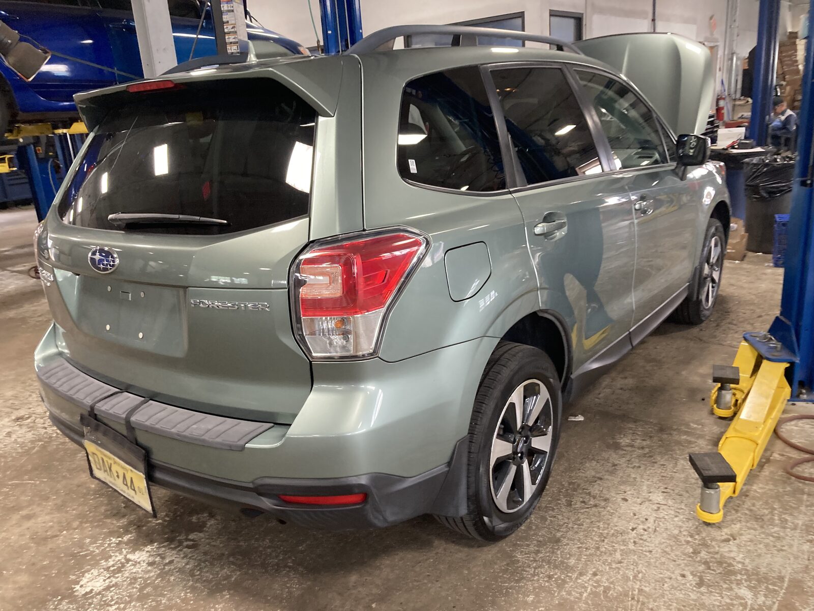 A vehicle raised on a lift during a Car Crush Guru inspection